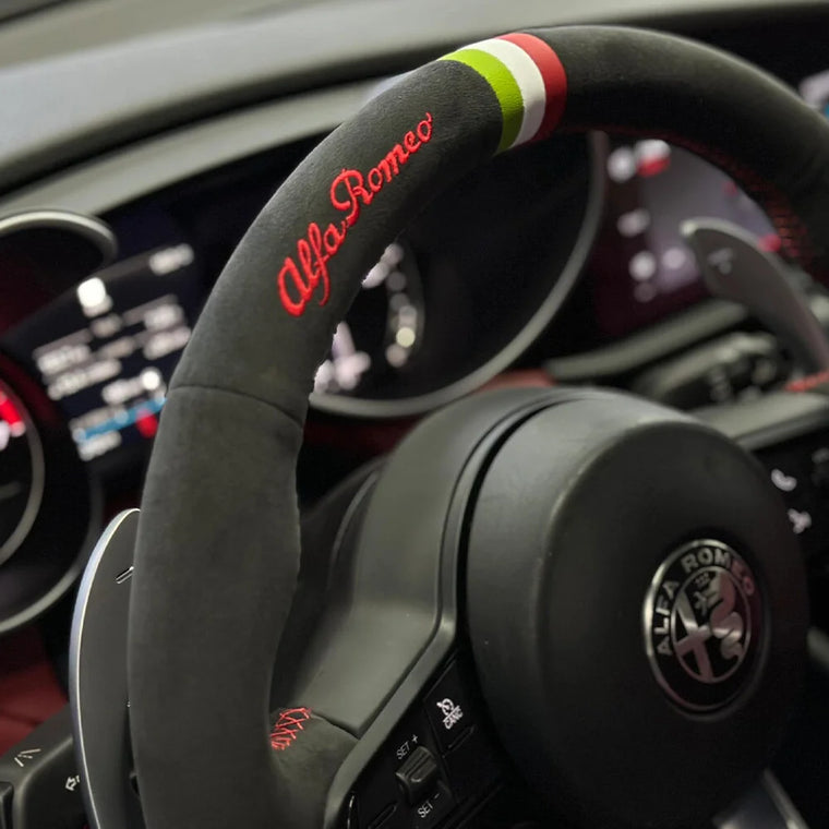 custom lettering embroidered on a black Italian Alcantara steering wheel cover