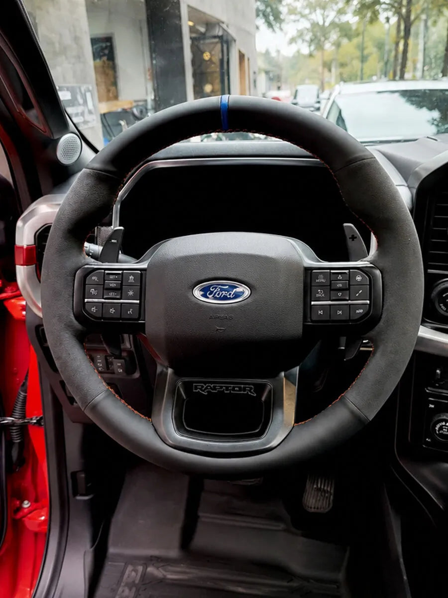 Ford custom steering wheel cover in black mixed materials with a blue center marker and red stitching
