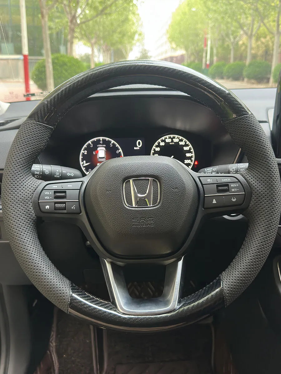 Custom Honda steering wheel cover with carbon fiber style sections and perforated leather side grips