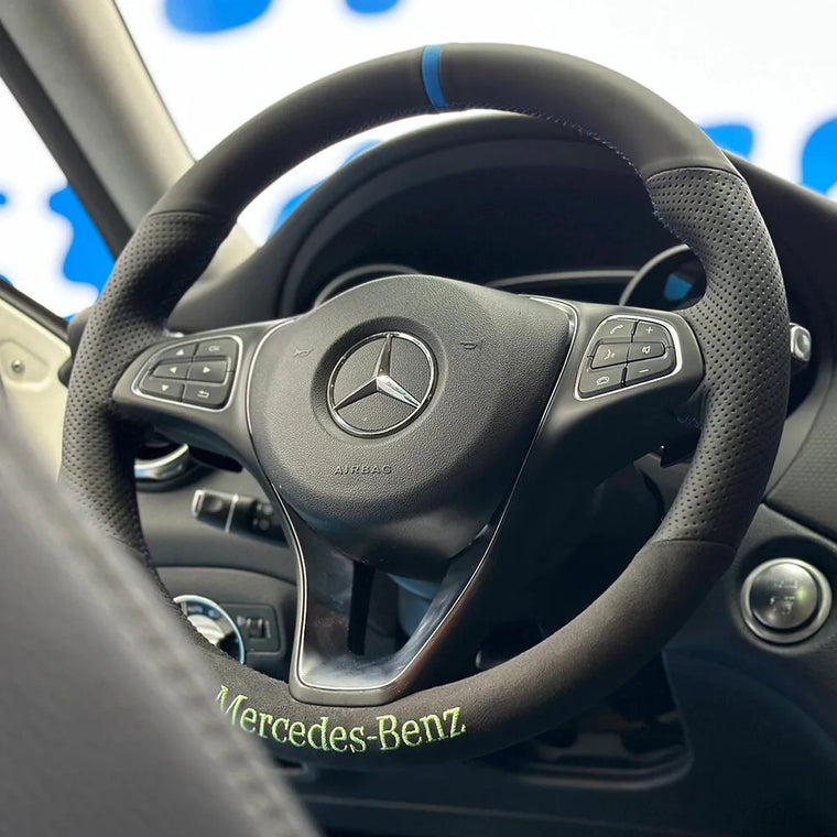 Mercedes-Benz steering wheel with dark Alcantara, green lettering embroidery and a blue center marker
