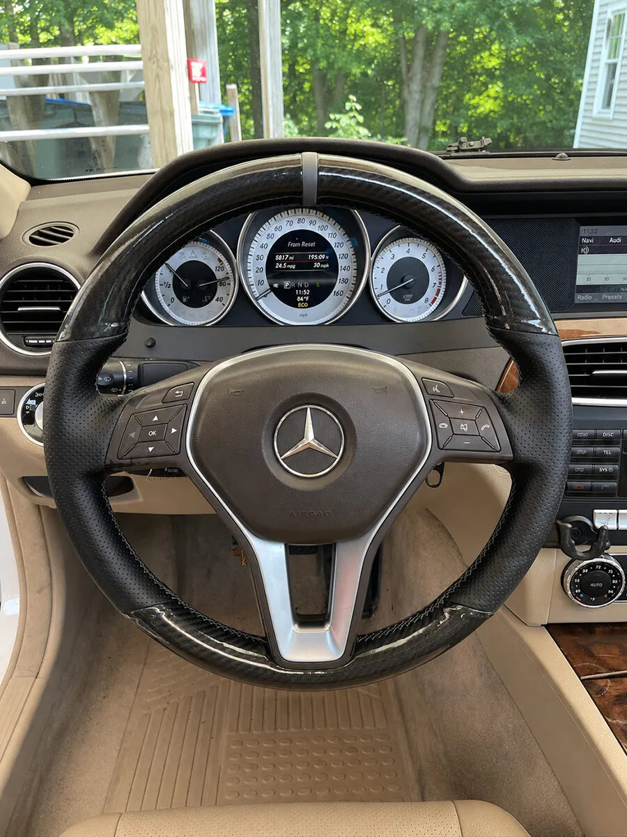 Mercedes-Benz custom steering wheel cover with carbon-fiber-style trim and black perforated leather