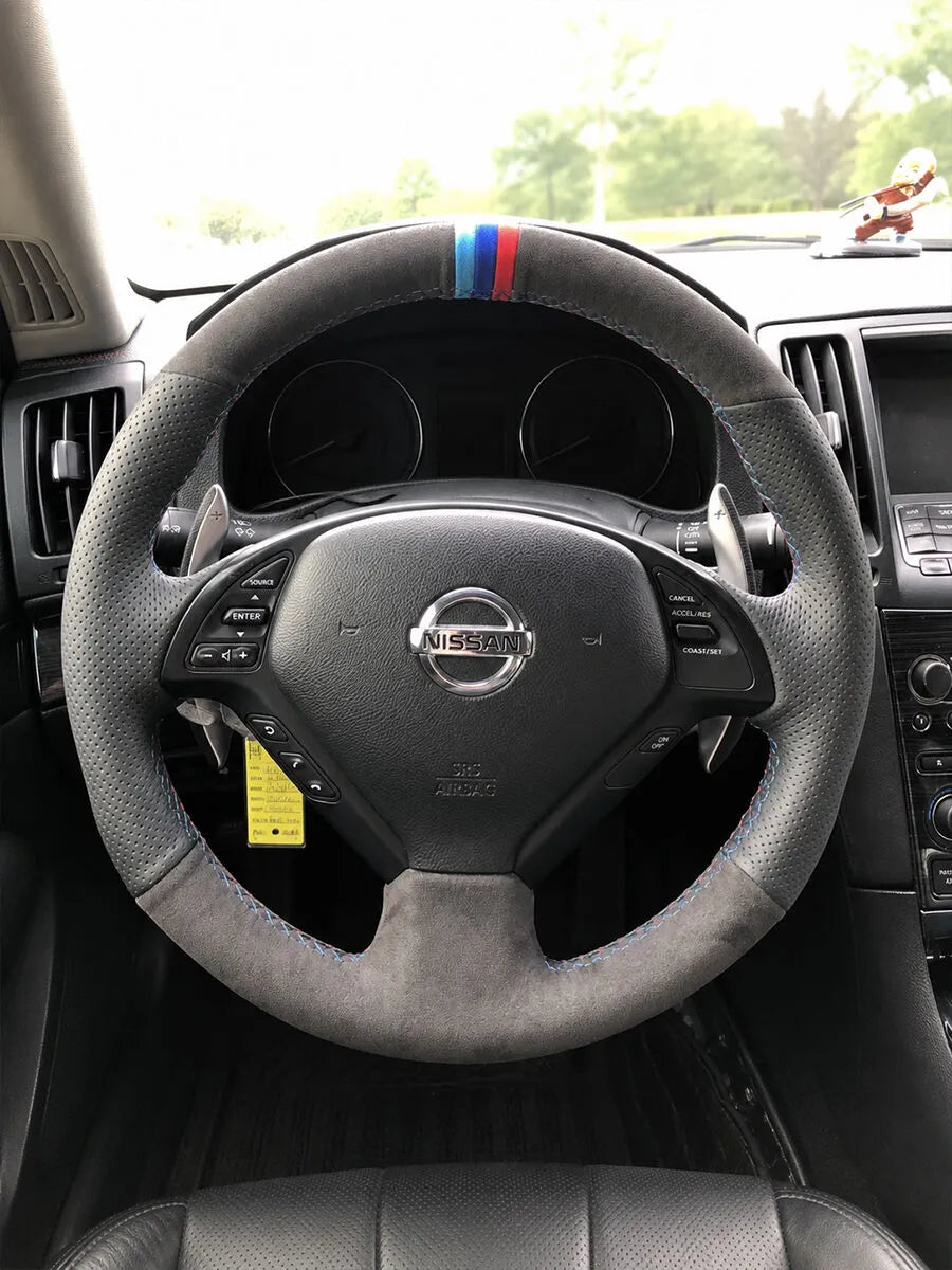 Nissan custom steering wheel cover in gray Italian Alcantara with perforated grips and a blue-red center marker