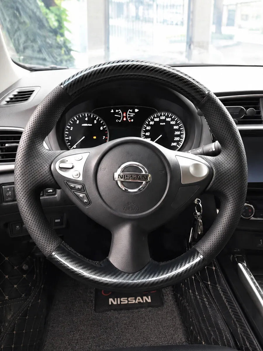 Nissan custom steering wheel cover with carbon-fiber-style sections and black perforated leather grips