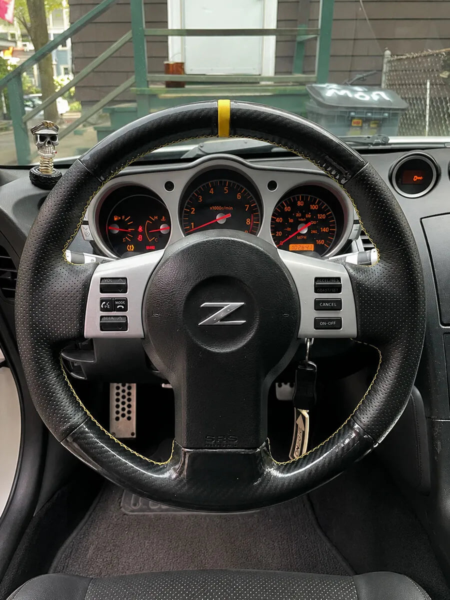 Nissan Z custom steering wheel cover with carbon-fiber-style sections, perforated grips and yellow details