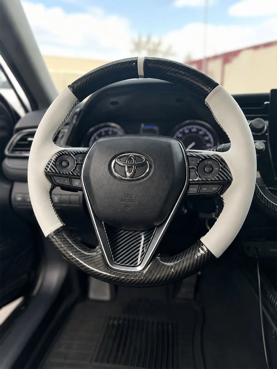Toyota Corolla steering wheel with carbon-fiber-style sections and white faux leather sides