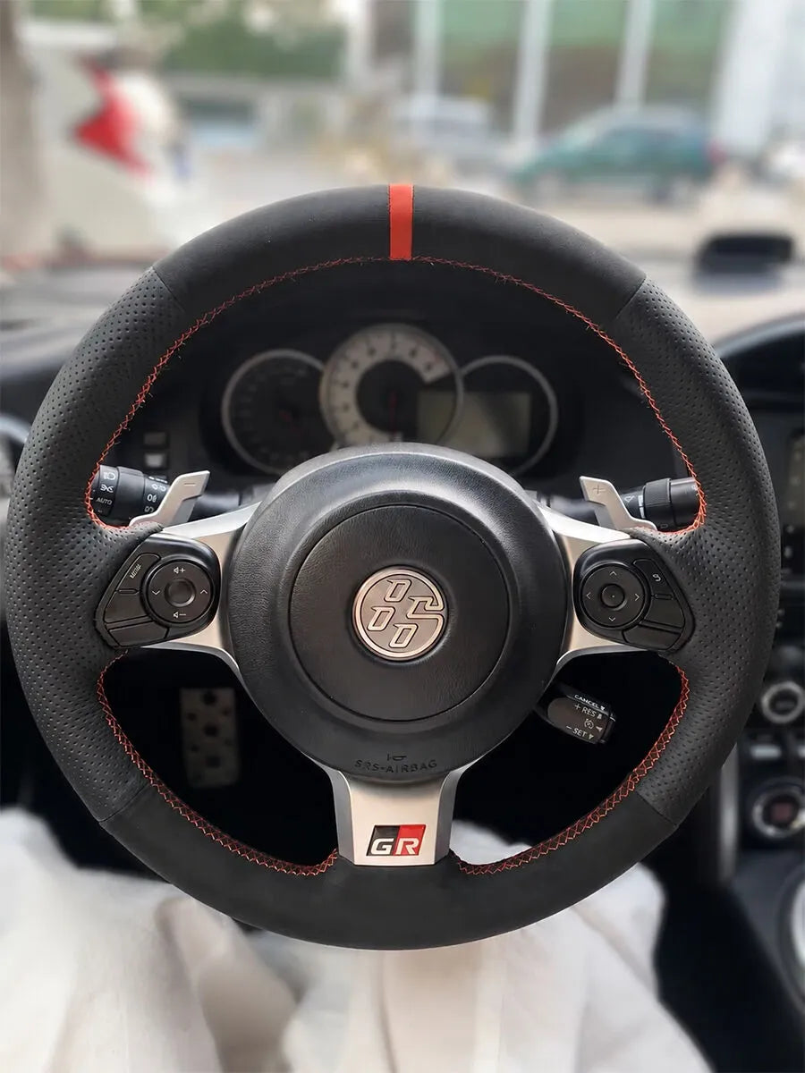Toyota 86 steering wheel with black Italian Alcantara, perforated Nappa sides, and a red center stripe